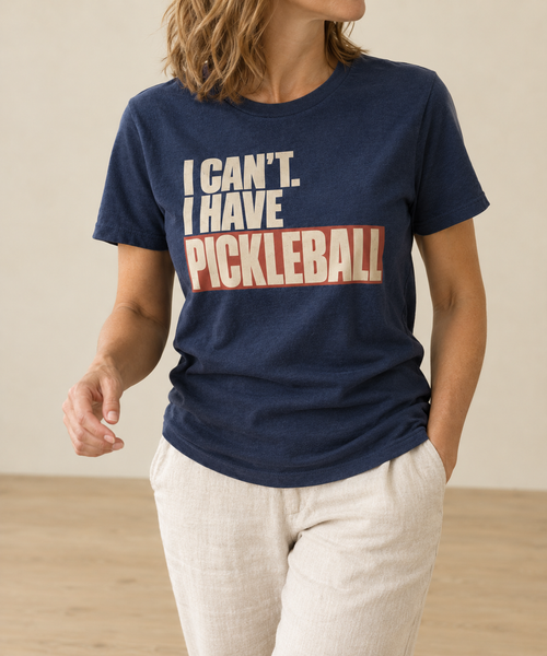 Navy t-shirt with a bold retro cream and terracotta print reading I Can't. I Have Pickleball.